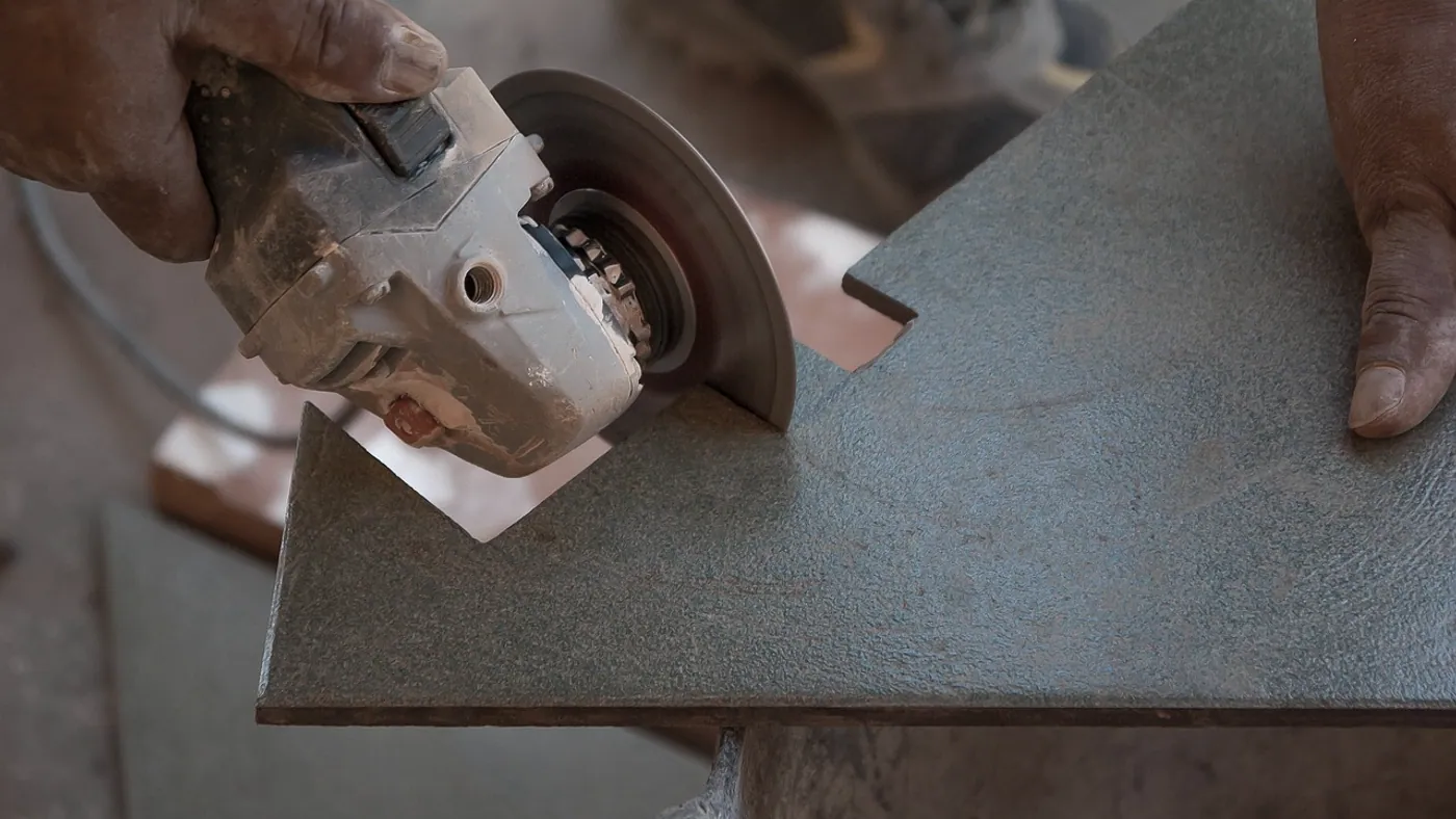 A notched trowel drawn through tile adhesive leaving deep even ridges